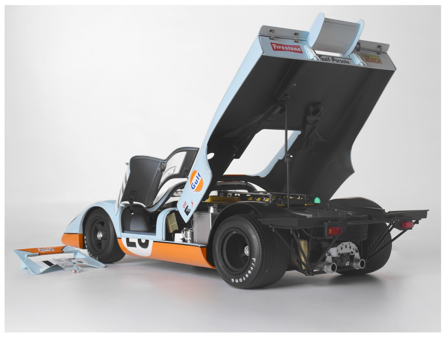 Rear angled view with body and doors open. Bonnet cover off & on the floor at the side of vehicle.