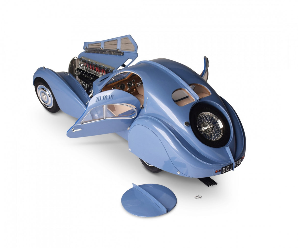 Rear angled shot showing both doors open, engine bay flap open & spare wheel cover on the floor at the side of the Bugatti