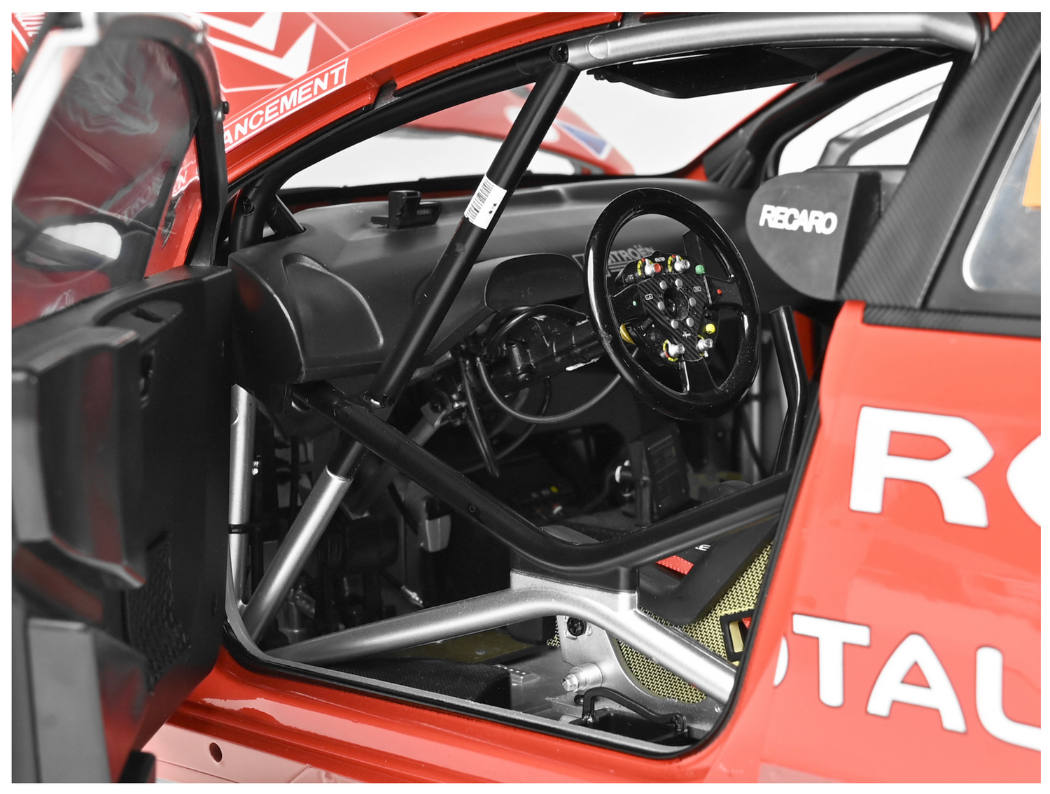 Looking inside to the drivers cockpit with the door open. Showing roll cage & steering wheel